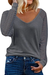 Detail of grey V-neck top showing semi-transparent striped patchwork on the sleeves