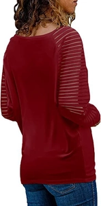 Detail of burgundy long sleeve top showing transparent striped patchwork sleeves on a model
