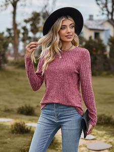 Close-up of pink long sleeve knit top with ribbed texture and classic round neck