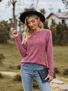 Detail of dusty rose ribbed knit long sleeve top with textured round neckline and fabric