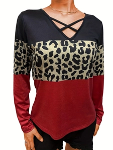 Detail of V-neck top with leopard print stitching and crisscross strap design