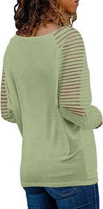 Detail view of sage green top featuring sheer mesh stripe patchwork on long sleeves