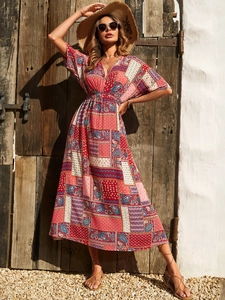 Detail of bohemian geometric print maxi dress with V-neckline and high waist in outdoor light