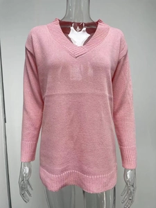 Detailed view of pink V-neck knit sweater featuring ribbed cuffs and a casual straight fit