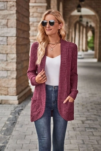 Detail shot of the ribbed knit texture and square patch pockets on a deep plum cardigan