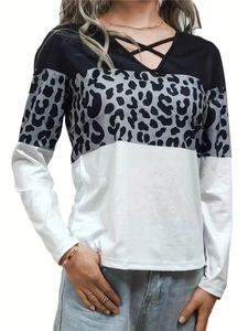 Detail of V-neck top showing leopard print patchwork and black lace-up cross strap design