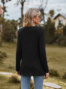 Detail of ribbed knit texture on the back of a slim-fit long-sleeve top in dark grey