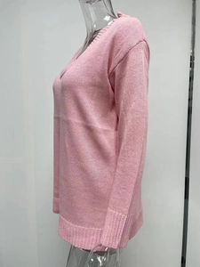 Detail of pink V-neck knit sweater showing ribbed cuffs and textured stitch pattern