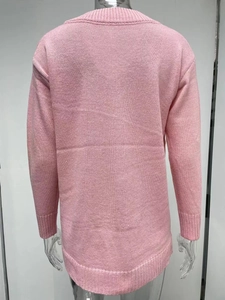 Detail view of pink knit sweater back featuring fine texture and ribbed hem cuffs