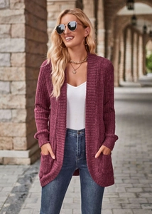 Close-up of wine red ribbed knit cardigan with side pockets and a textured longline fit