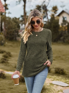 Close-up of dark green ribbed knit long sleeve top with a classic round neck design