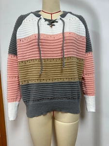 Detail of multi-color patchwork knit hoodie with V-neck hollow texture and lace-up neck