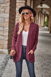 Detail of ribbed knit texture on a long-sleeved burgundy open cardigan with side pockets
