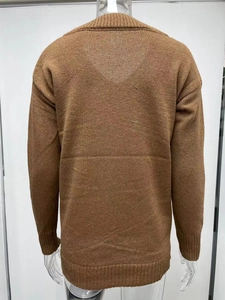 Rear view of brown V-neck knit sweater featuring soft long sleeves and ribbed texture