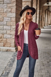 Detail of burgundy ribbed knit long cardigan featuring functional side pockets