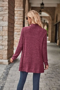 Macro view of the burgundy ribbed knit texture on the long-sleeved cardigan sweater
