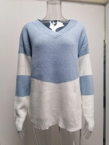 Detailed view of blue and white striped knit texture and ribbed cuffs on v-neck sweater