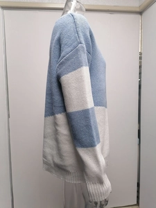 Detail of color-block knit sweater featuring ribbed hem and dropped shoulder seams