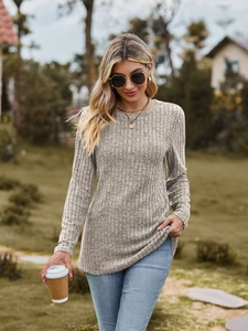 Close-up of oatmeal ribbed knit texture on a long-sleeve slim-fit crew neck top