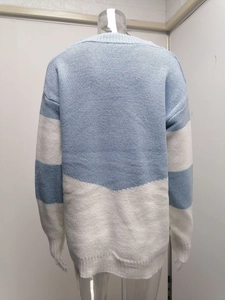 Detailed back view of a loose V-neck knitted sweater with blue and white color-block design