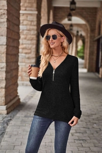 Dettaglio maglia nera a coste a maniche lunghe con scollo a V e cerniera casual