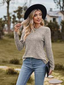 Detail of grey ribbed knit long sleeve top with crew neck texture on a model
