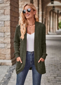 Detail of ribbed knit texture and side pocket on long-sleeved dark green cardigan