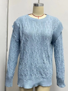 Detailed cable knit pattern on light blue long sleeve sweater with ribbed cuffs