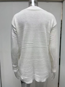 Detailed back view of white long-sleeved knit sweater with ribbed cuffs and hem