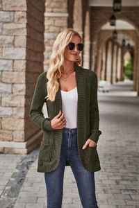 Detail showing the ribbed knit texture and front pockets of the long green cardigan
