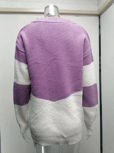 Close-up of purple and white color-block knit sweater with ribbed cuffs and hem details