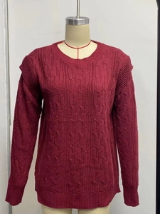 Detail of cable knit texture and ribbed cuffs on thick burgundy crewneck sweater