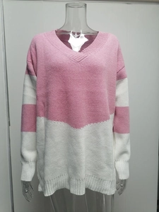 Detail of V-neck pink and white striped sweater featuring ribbed cuffs and knit texture