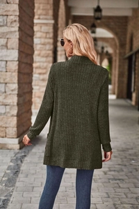 Detail view of dark green ribbed knit texture on a long-sleeved casual cardigan