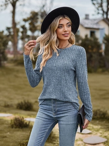 Detail of ribbed knit texture on blue-grey long-sleeve crewneck top for women