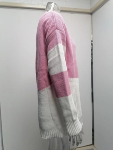 Detail of pink and white color block sweater showing ribbed knit cuffs and hem texture
