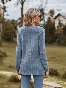 Detail of grey ribbed long sleeve knit top showing the vertical texture and back fit
