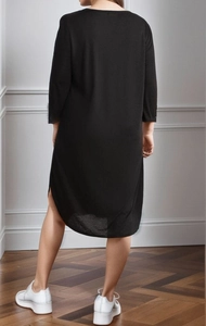 Back view of a long-sleeved black midi dress featuring a curved split hem and round neck