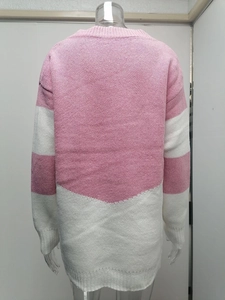 Close-up of pink and white color-block knit sweater with ribbed cuffs and hem detail