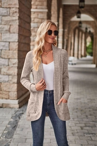 Detail of light brown ribbed knit cardigan featuring long sleeves and functional side pockets