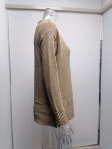 Detail of ribbed cuffs and hem on a solid brown knit sweater for autumn winter