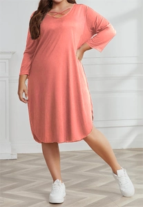 Detail of coral pink plus size dress featuring lace-up V-neck and side slit hem design