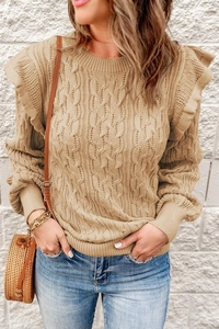 Close-up of cable knit sweater detail with elegant ruffle shoulder and textured knit