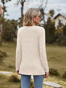 Detail of ribbed knit texture on light beige long sleeve slim fit round neck top