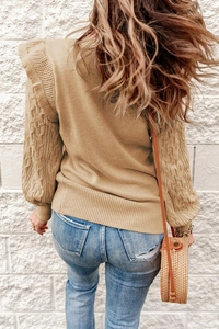 Detailed back view of camel knit sweater with cable knit sleeves and ruffle shoulder detail