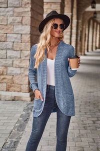 Detailed close-up of ribbed knit texture on a hazy blue long cardigan with side pockets