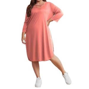 Plus size coral pink midi dress featuring crisscross V-neck and stylish curved hem