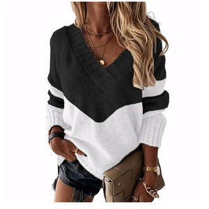 Detail of color block V-neck knitted sweater with ribbed cuffs and textured fabric