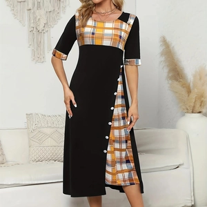 Detail view of round neck dress with colorful plaid patchwork and decorative white buttons