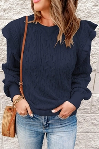Close-up of deep blue cable knit sweater featuring ruffled shoulders and ribbed cuffs